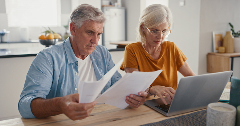 A senior couple reading a COLA increase announcement from the Social Security Administration.