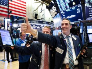 Stock market today: Dow notches record high after strong jobs report eases slowdown worries