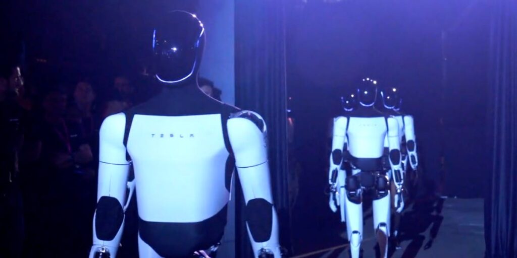 Optimus robots danced on a lit-up stage and served drinks at Tesla’s robotaxi event